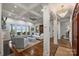 Spacious living room featuring a coffered ceiling, white pillars, hardwood floors, and expansive water views at 299 Barber Loop, Mooresville, NC 28117