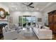 Bright living room with tray ceiling, hardwood flooring, doors to the outside, and comfortable seating at 299 Barber Loop, Mooresville, NC 28117