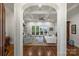 Elegant living room with coffered ceilings, hardwood floors, and doors that provide stunning lake views at 299 Barber Loop, Mooresville, NC 28117