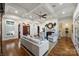 Open-concept living room boasting hardwood floors, a white fireplace, coffered ceilings, and lots of natural light at 299 Barber Loop, Mooresville, NC 28117