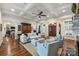 Elegant living room featuring a tray ceiling, hardwood floors, comfortable seating, and an arched doorway at 299 Barber Loop, Mooresville, NC 28117