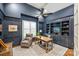 The study has dark blue paneled walls, custom shelves, and a ceiling fan at 299 Barber Loop, Mooresville, NC 28117