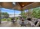 Covered porch overlooking a lake and featuring comfortable seating arrangements, perfect for relaxing outdoors at 299 Barber Loop, Mooresville, NC 28117