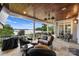 Covered patio with lake view features comfortable wicker seating and tables at 299 Barber Loop, Mooresville, NC 28117
