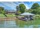 Beautiful waterfront property with a well-maintained home, manicured lawn, and private dock for easy lake access at 299 Barber Loop, Mooresville, NC 28117