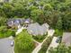 Aerial view shows a brick home with a manicured lawn, mature trees, and is nestled in a desirable neighborhood at 3420 Maryhurst Ln, Charlotte, NC 28226