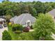 Aerial view of a brick home featuring mature landscaping, a well-maintained lawn, and inviting curb appeal at 3420 Maryhurst Ln, Charlotte, NC 28226