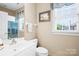 Bright bathroom with a window, towel rack, and vanity with a sink at 3420 Maryhurst Ln, Charlotte, NC 28226