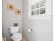 Simple bathroom featuring a toilet, small window, and tissue holder at 3420 Maryhurst Ln, Charlotte, NC 28226