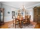 Elegant dining area featuring hardwood floors, a chandelier, and a view into adjacent living spaces at 3420 Maryhurst Ln, Charlotte, NC 28226
