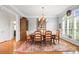 Formal dining room with hardwood floors, classic decor, and a large window for natural light at 3420 Maryhurst Ln, Charlotte, NC 28226