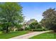 Beautiful brick home showcasing its landscaped front yard, winding driveway, and lush mature trees at 3420 Maryhurst Ln, Charlotte, NC 28226