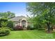 Beautiful brick home with a manicured lawn and a grand entrance, enhanced by lush landscaping at 3420 Maryhurst Ln, Charlotte, NC 28226