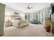 Bright main bedroom features large windows, sitting area, and neutral carpeting at 3420 Maryhurst Ln, Charlotte, NC 28226