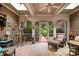 Brick sunroom with checkered furniture and view of the garden at 3420 Maryhurst Ln, Charlotte, NC 28226