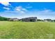 Large backyard features a well-maintained lawn, patio area, and dark blue siding at 3615 Kimber Ln, Sherrills Ford, NC 28673