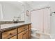 Bright bathroom features a single sink vanity with granite counters and a shower with patterned curtain at 3615 Kimber Ln, Sherrills Ford, NC 28673
