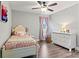 A cozy bedroom with white dresser, a pink bed, ceiling fan, and pink curtains at 3615 Kimber Ln, Sherrills Ford, NC 28673