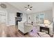 Cozy living room with a stone fireplace, ceiling fan, and light-filled windows at 3615 Kimber Ln, Sherrills Ford, NC 28673