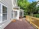 This home features a stained back deck that leads to a screened-in porch and showcases the home's outdoor space at 6005 Abergele Ln, Matthews, NC 28104