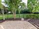 This home features a brick patio that leads into an expansive backyard surrounded by manicured landscaping at 6005 Abergele Ln, Matthews, NC 28104
