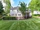 A spacious backyard features a stained wooden deck and brick patio for outdoor living and entertaining at 6005 Abergele Ln, Matthews, NC 28104