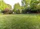 Lush backyard with mature trees and manicured lawn; perfect for outdoor enjoyment and relaxation at 6005 Abergele Ln, Matthews, NC 28104