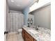 Bathroom features granite countertop, modern vanity, and decorative mirror at 6005 Abergele Ln, Matthews, NC 28104