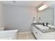 Bright bathroom features a modern sink with granite countertop and large mirror at 6005 Abergele Ln, Matthews, NC 28104