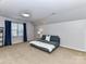 Attic Bedroom with a comfy sofa, large window, and neutral carpet at 6005 Abergele Ln, Matthews, NC 28104
