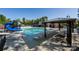 A large community pool with a slide, pool furniture, and shaded picnic area offers resort-style amenities at 6005 Abergele Ln, Matthews, NC 28104
