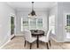 Charming dining area with large windows, chandelier, and access to the backyard at 6005 Abergele Ln, Matthews, NC 28104