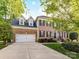 Charming two-story brick home with a well-manicured lawn and a two-car garage at 6005 Abergele Ln, Matthews, NC 28104