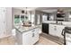 Kitchen with granite countertops and stainless steel appliances open to the dining and living areas at 6005 Abergele Ln, Matthews, NC 28104