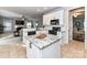 Open kitchen boasts granite countertops, white cabinets, and modern appliances overlooking the living room at 6005 Abergele Ln, Matthews, NC 28104