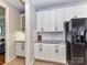 Kitchen features granite countertops, white cabinets, stainless steel appliances and tile backsplash at 6005 Abergele Ln, Matthews, NC 28104