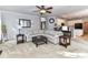 Open-concept living room connected to the kitchen with a ceiling fan at 6005 Abergele Ln, Matthews, NC 28104