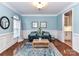 Bright living room featuring wood floors, a blue couch, and stylish decor at 6005 Abergele Ln, Matthews, NC 28104