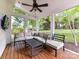 Covered patio with comfortable seating, ceiling fan, and open backyard views at 6005 Abergele Ln, Matthews, NC 28104