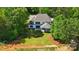 Expansive backyard featuring a well-manicured lawn, modern white home exterior, and surrounding lush trees at 6712 Cove Ln, Sherrills Ford, NC 28673