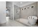 Modern bathroom with walk-in shower, soaking tub, and three tiled windows overlooking the yard at 6712 Cove Ln, Sherrills Ford, NC 28673