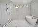 New bathroom features a walk-in shower, soaking tub, and three tiled windows overlooking the yard at 6712 Cove Ln, Sherrills Ford, NC 28673