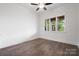 Bright bedroom features hardwood floors, ceiling fan and a window overlooking the porch at 6712 Cove Ln, Sherrills Ford, NC 28673