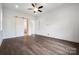Bright Primary bedroom features a ceiling fan, hardwood floors, and a sliding barn door to en suite bathroom at 6712 Cove Ln, Sherrills Ford, NC 28673