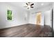 Primary bedroom boasts windows and hardwood flooring with barn door to bathroom at 6712 Cove Ln, Sherrills Ford, NC 28673