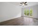 Bright bedroom features hardwood floors and a window overlooking the backyard at 6712 Cove Ln, Sherrills Ford, NC 28673