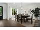 Elegant dining room featuring a modern chandelier, large windows, and stylish decor at 6712 Cove Ln, Sherrills Ford, NC 28673