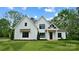 Charming two-story white farmhouse with black trim, a gabled roof, and a well-maintained lawn at 6712 Cove Ln, Sherrills Ford, NC 28673