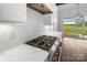 Close up of modern gas cooktop, counter space and white tile backsplash at 6712 Cove Ln, Sherrills Ford, NC 28673