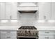 Modern kitchen features white cabinets, subway tile backsplash, and a stainless steel gas range at 6712 Cove Ln, Sherrills Ford, NC 28673